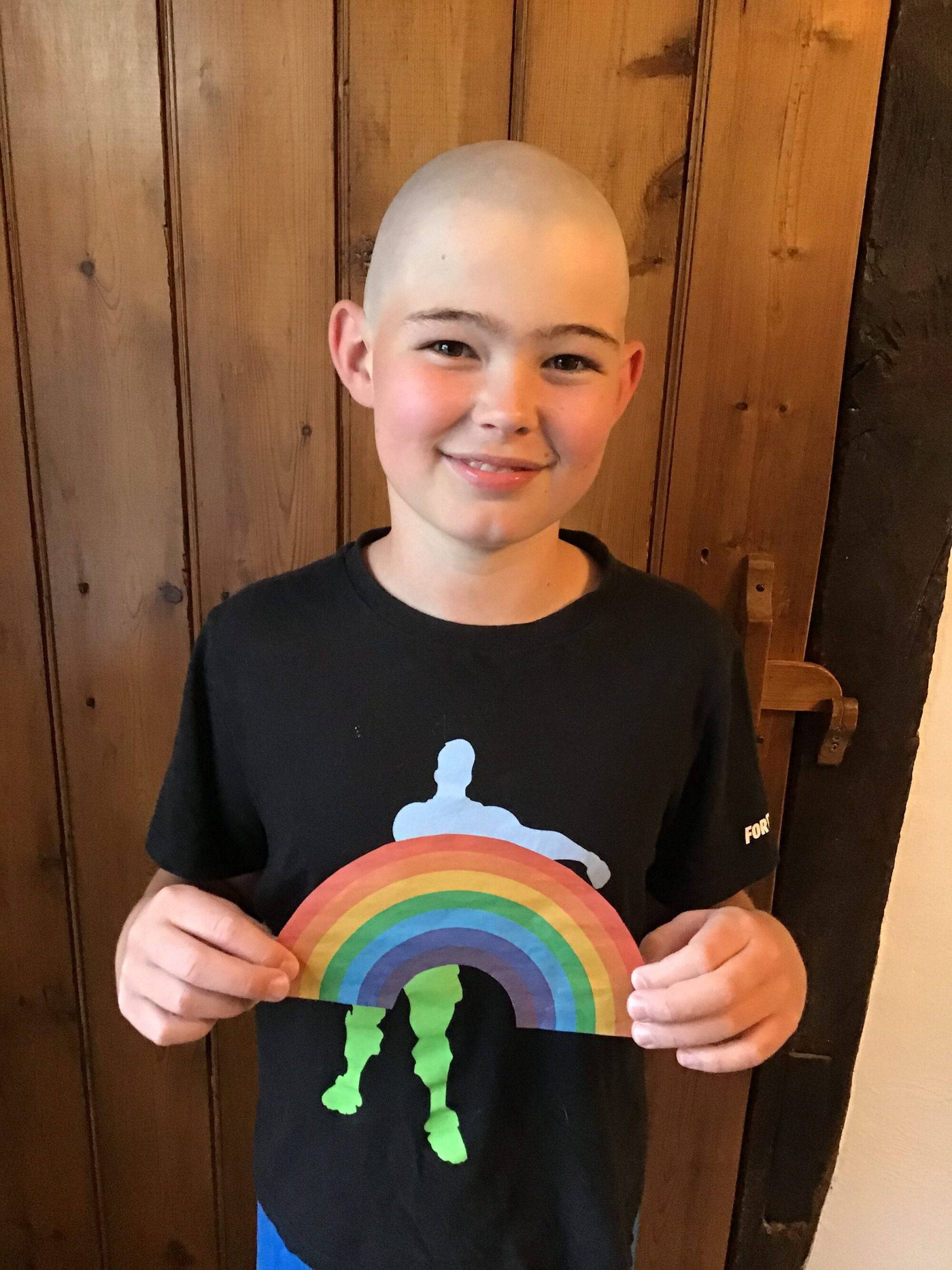 George smiling proudly after his head shave