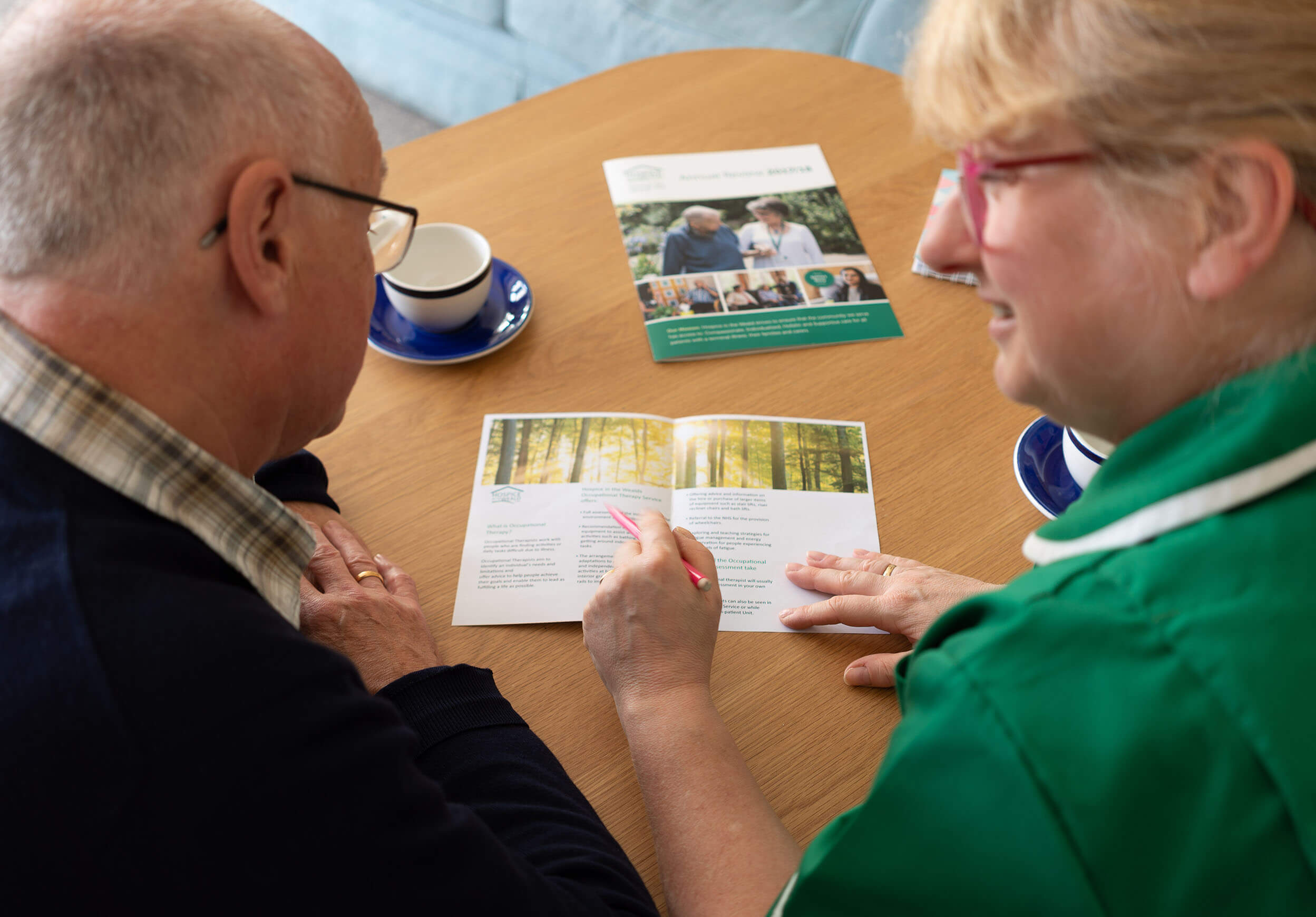 Hospice staff explaining leaflet