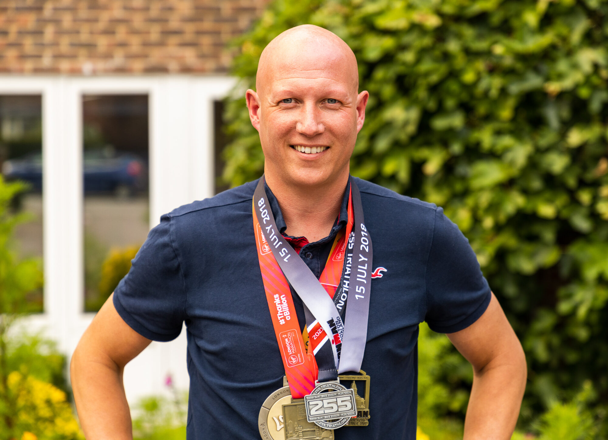 Steve Lindsey outside Hospice with Medals