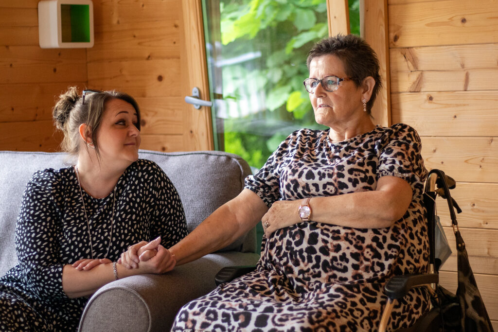 Karen and Siobhan smiling at each other in the Hospice Summer House