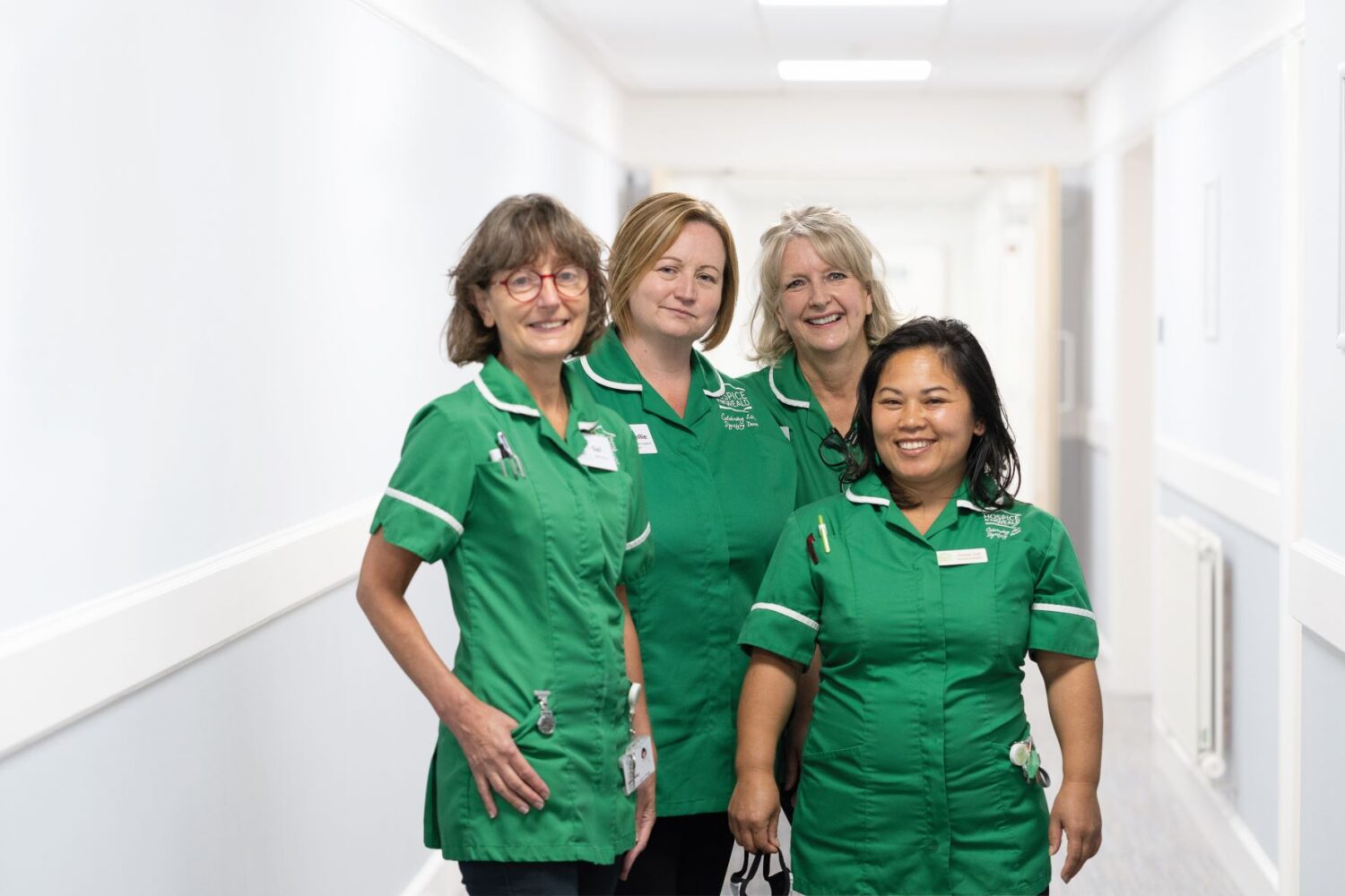 4 nurses in green Hospice in the Weald uniforms