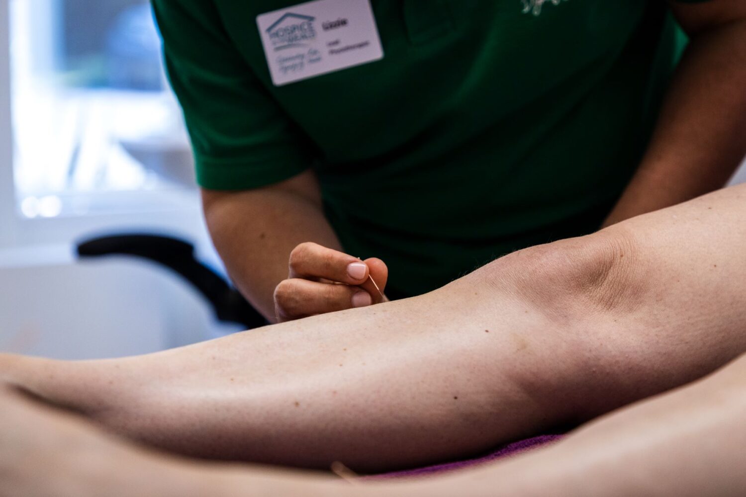 Lizzie performing acupuncture to a patient